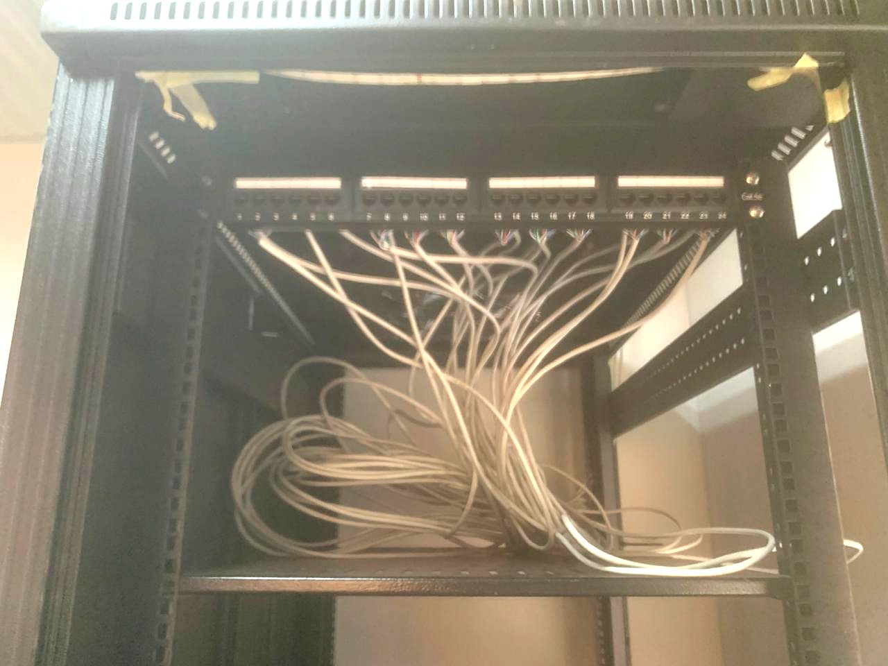 Terminated Cat6 runs punched down into the rear of a patch panel inside a network cabinet