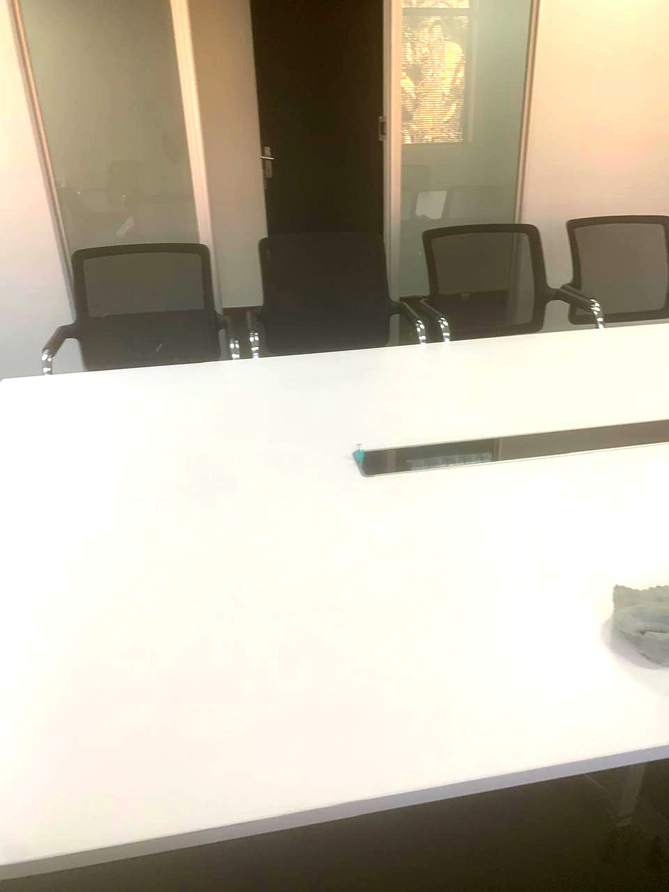 Boardroom table with an integrated cable channel carrying network cabling